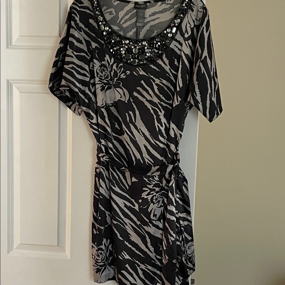 Black and silver dress. Knee length. Jeweled neckline. Tie belt.